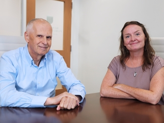A man and a woman sit at a table.