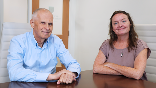 A man and a woman sit at a table.