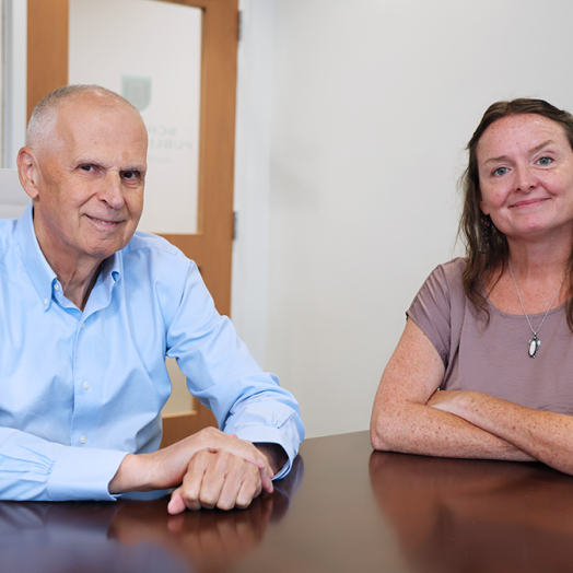 A man and a woman sit at a table.