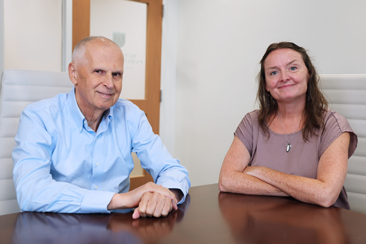 A man and a woman sit at a table.