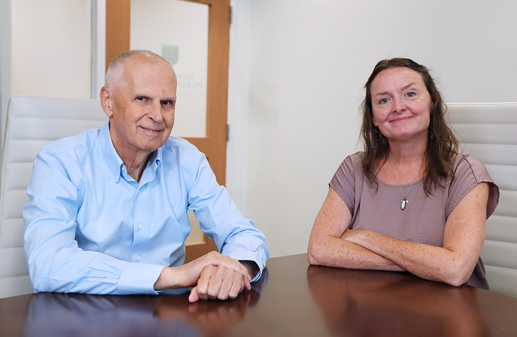 A man and a woman sit at a table.