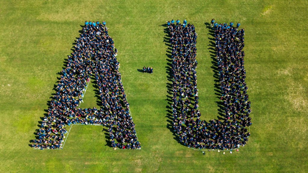 An aerial shot of many students gathered to from the letters "A" and "U"