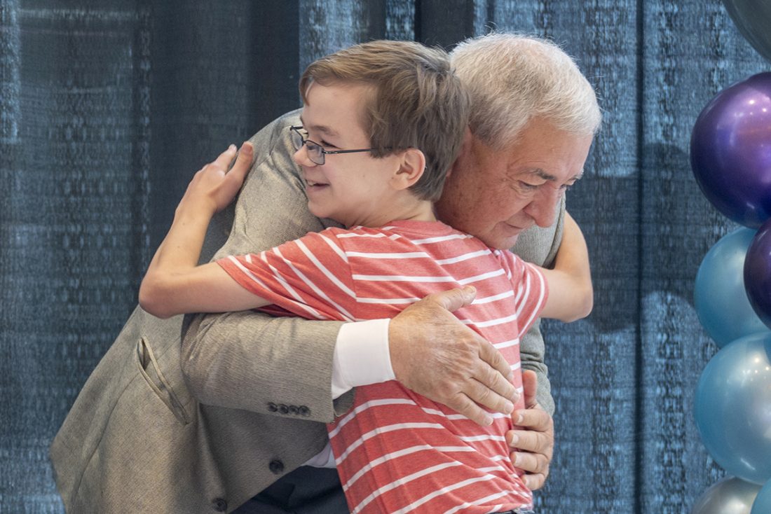 man and boy hug