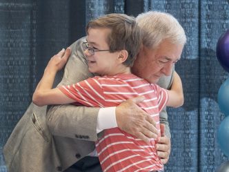 man and boy hug