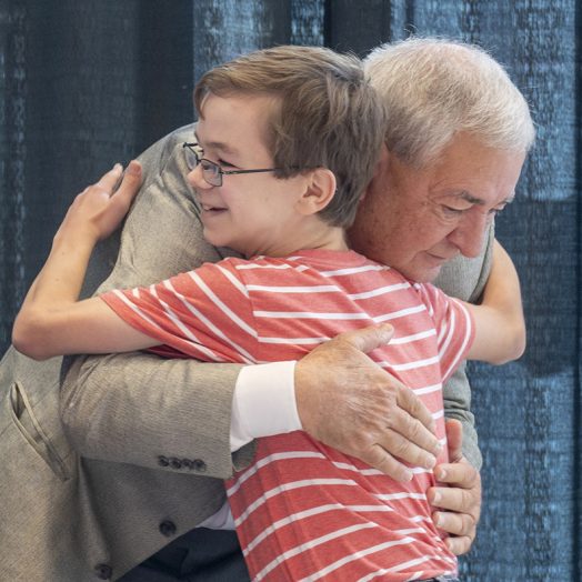 man and boy hug