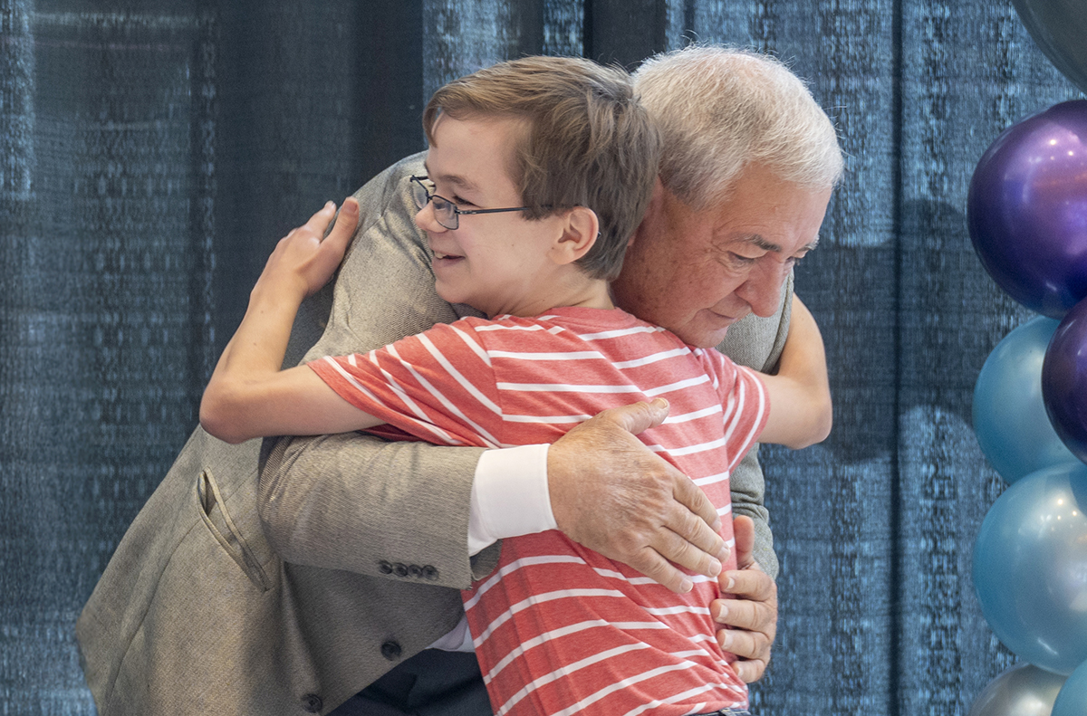 man and boy hug