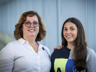 Two women smiling while posing for a photo