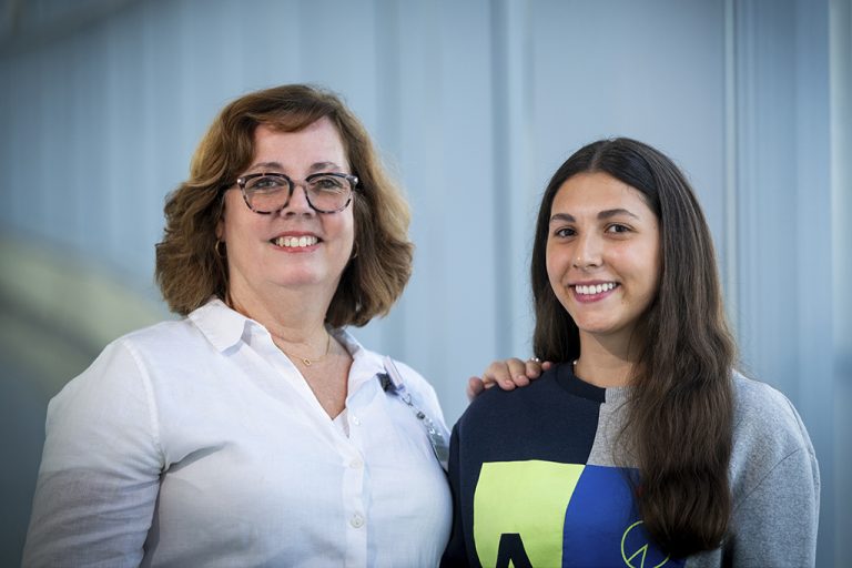 Two women smiling while posing for a photo
