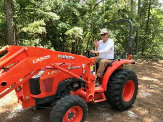 man drives tractor