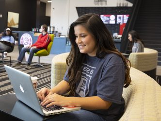 Female student using technology on campus