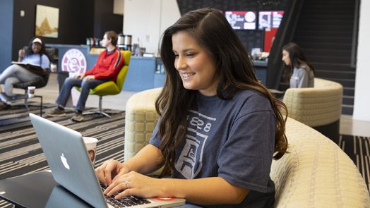 Female student using technology on campus