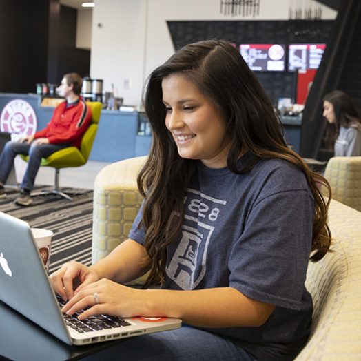 Female student using technology on campus