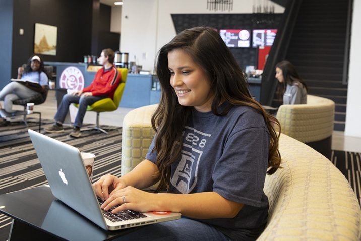 Female student using technology on campus