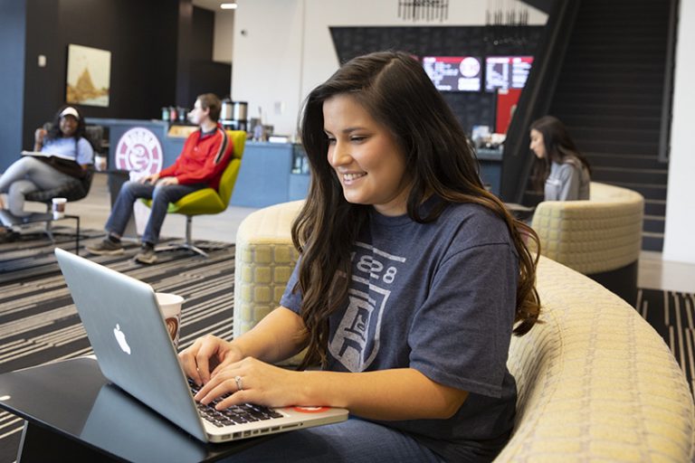 Female student using technology on campus