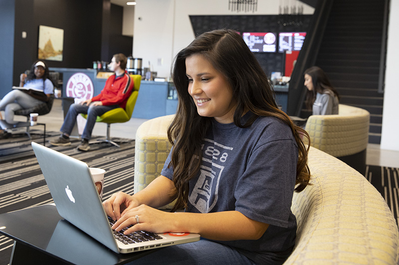 Female student using technology on campus