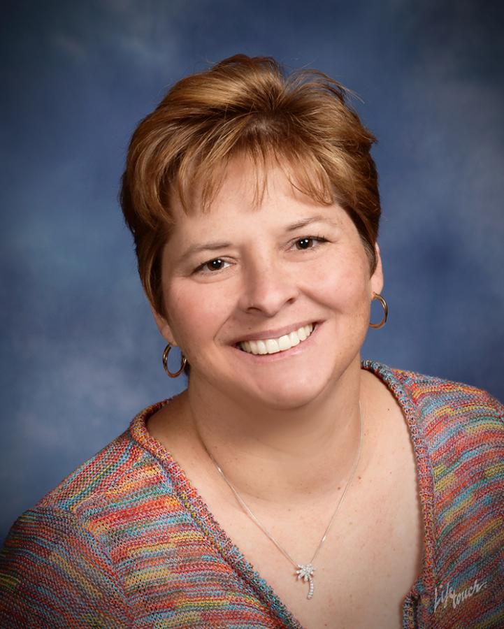 A woman's headshot of her smiling at the camera.