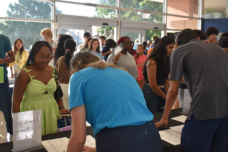 people standing around a table and talking