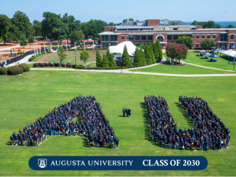 group of people gathered together in an A and U shape