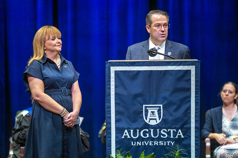 man and a woman standing at a podium