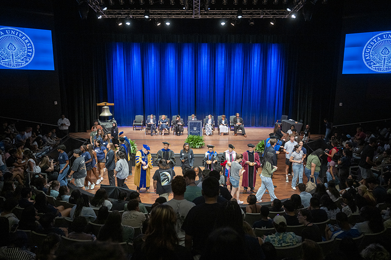 group of people seated and standing