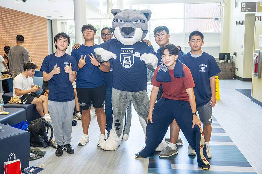 group of students standing with a cat mascot