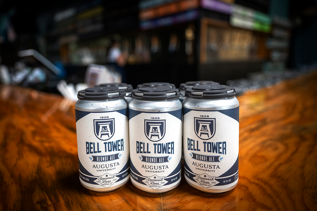 a six-pack of cans on a wooden surface