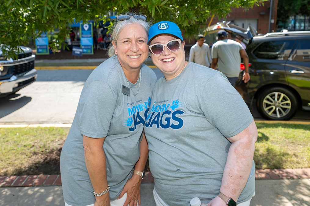 Two women in T-shirts smiling