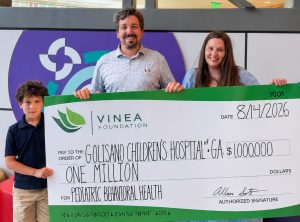 Soto Family holding symbolic check for $1 million