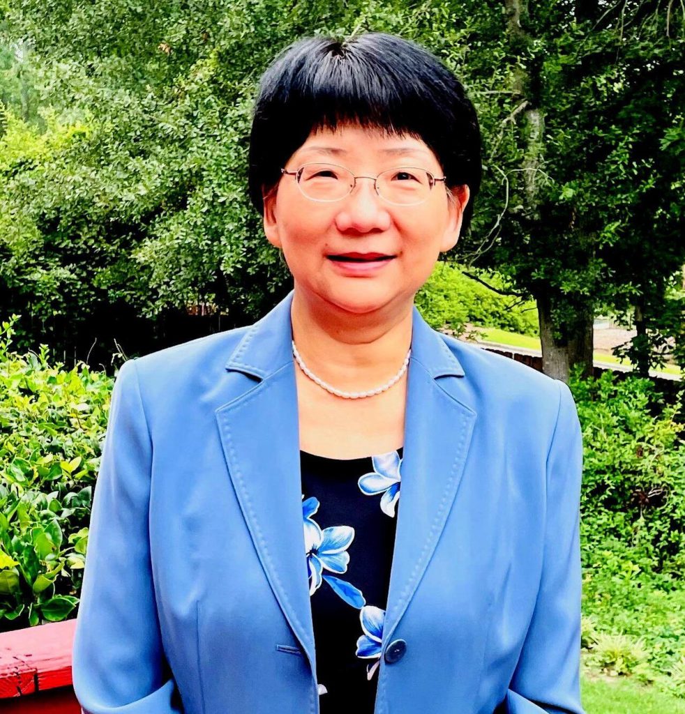 woman in a blue jacket smiling