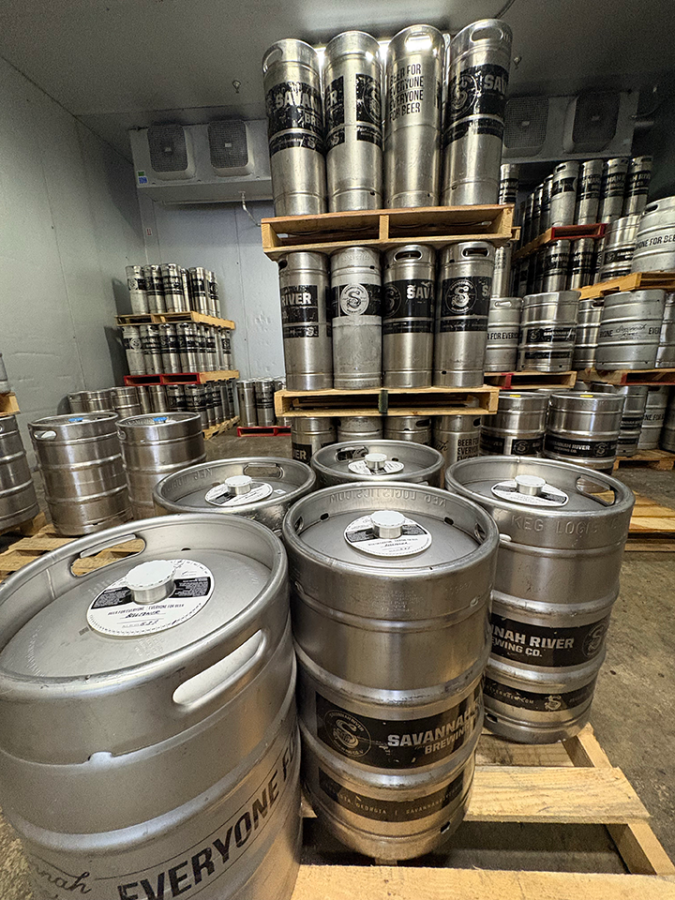 dozens of kegs on wooden pallets