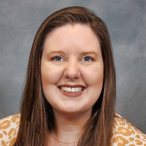 A middle-aged woman smiling for a photo