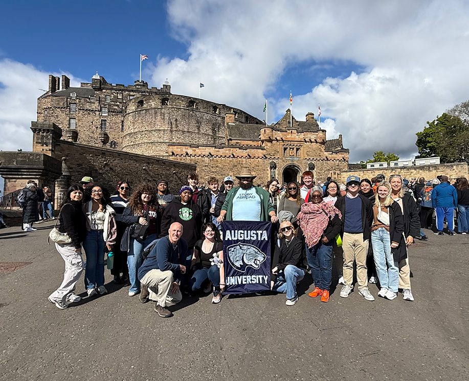 group of people, one holding a banner
