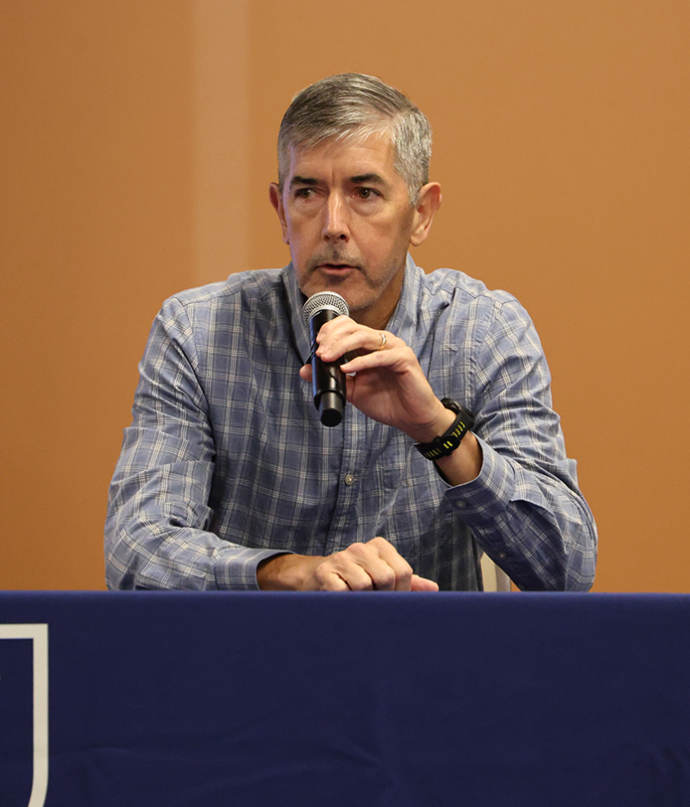 A man speaks into a microphone.