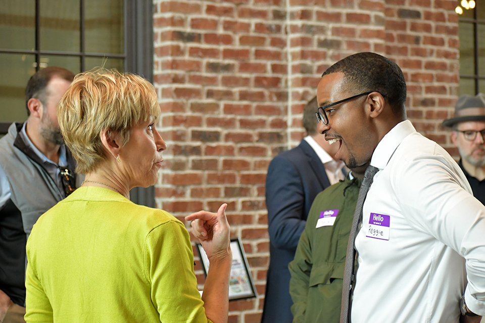Betsy VanDeusen, Ph.D., welcomes guest to the Connection for Life Open-House event at The HUB for Community Innovation.