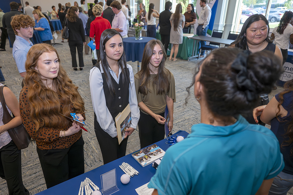 Students listen to a woman speaking