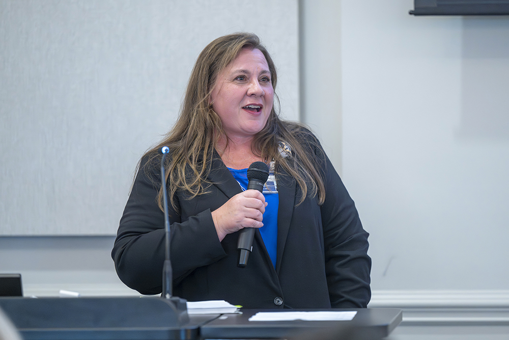 Woman speaking in front of a crowd
