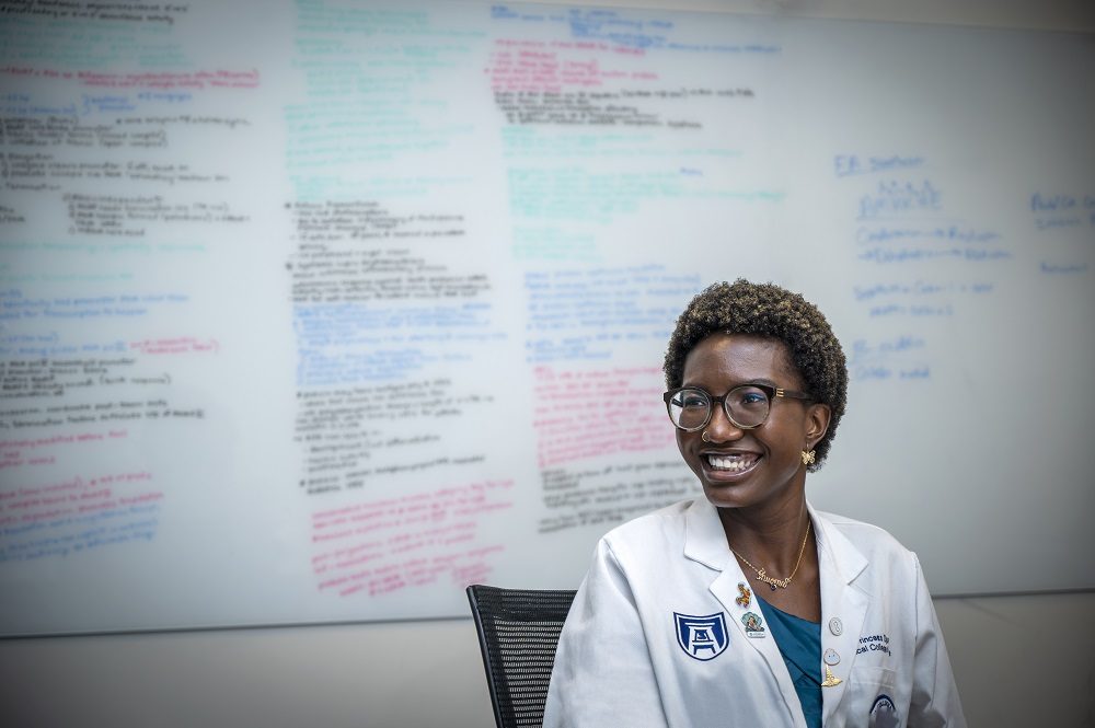 MCG student Princess Ogundu smiles as she talks with other students in one of the study-conference rooms at the J. Harold Harrison, M.D. Education Commons on the Augusta University Health Sciences campus in Friday afternoon August 20, 2021 in Augusta, Ga.  8/20/21 1:23:13 PM

Photo by Michael Holahan/Augusta University

Job #